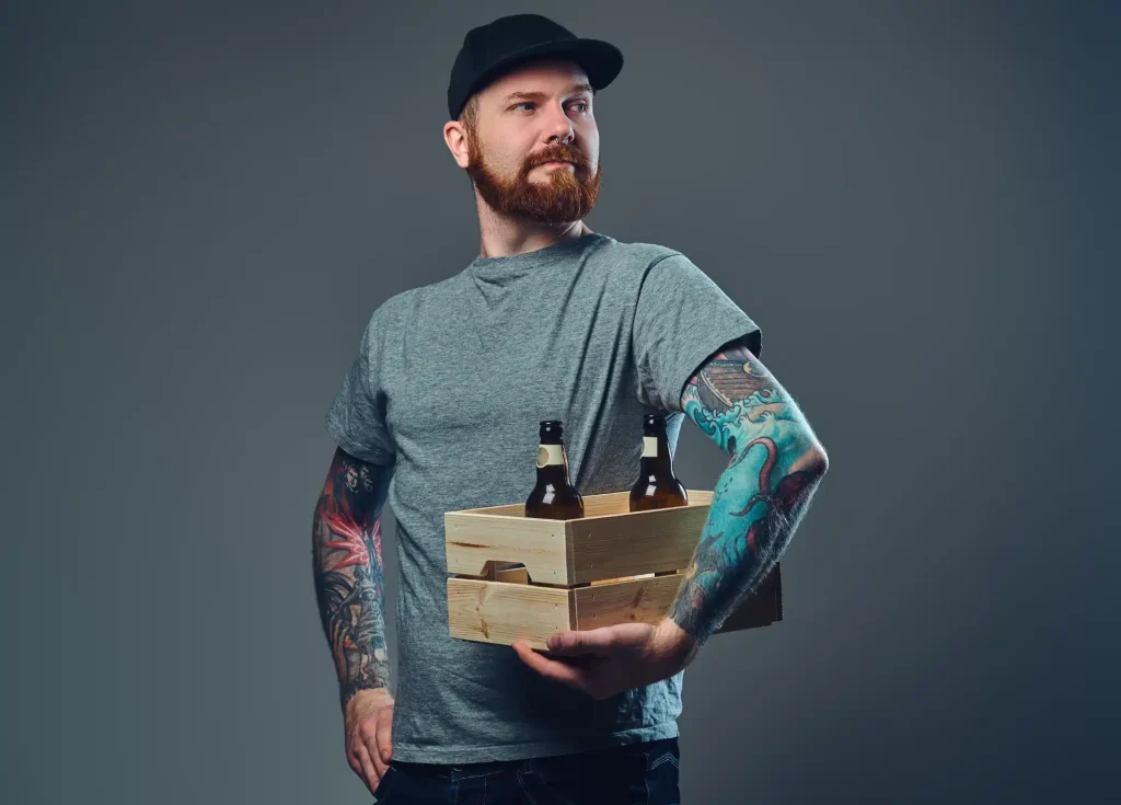 A delivery driver holding a wooden crate with craft beer bottles, showcasing liquor delivery services.