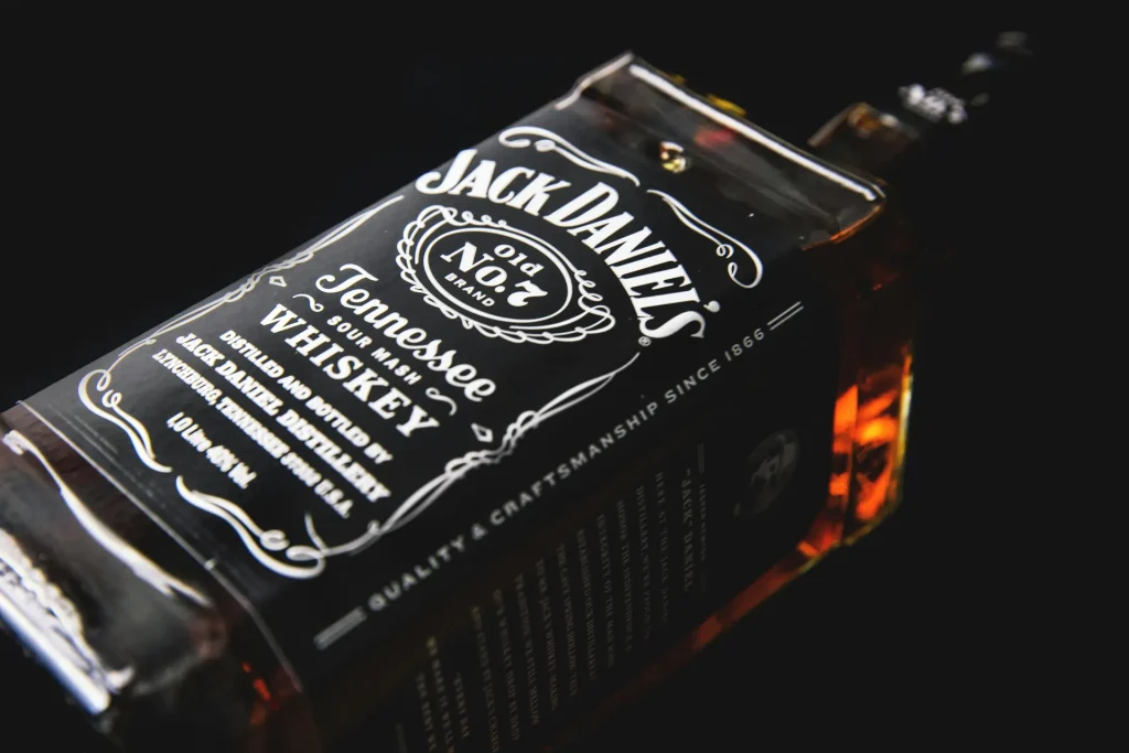 Close-up image of a Jack Daniel's Old No. 7 Tennessee Whiskey bottle, highlighting its iconic black-and-white label and amber liquid.